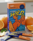 Hydro Wild supplement packaging with orange slices on a light surface