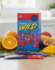 Hydro Wild fruit juice box with colorful packaging on a kitchen counter with fruits.